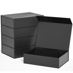 an open black box sitting on top of a white table next to another empty box