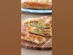 two plates with pastries on them sitting on a wooden table next to each other