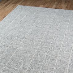 a white rug on top of a wooden floor