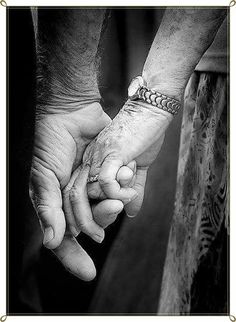 black and white photograph of two hands holding each other