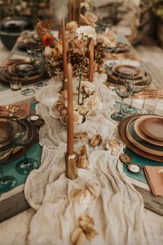 a long table is set with plates and place settings