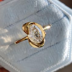 a gold ring with a white diamond in it