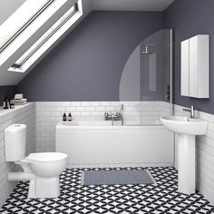 an attic bathroom with black and white tile flooring, skylight above the bathtub