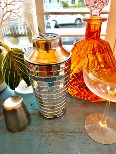 three different colored vases sitting on top of a table next to eachother