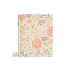 a small notebook with flowers and leaves on the cover, in peach pinks and green