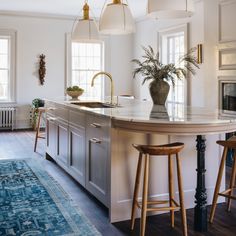 a kitchen island with two stools next to it