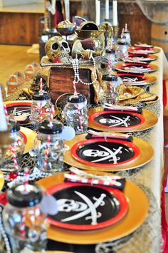 a long table is decorated with black and gold plates