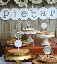 there is a dessert table with pies on it