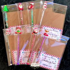 six christmas themed toothbrushes in envelopes with santa's helpers on them