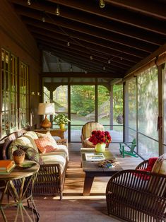 a living room filled with furniture and lots of windows