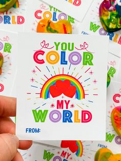 someone holding up a card that says you color my world