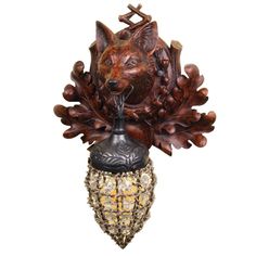 an animal head mounted on the side of a wooden wall hanging decoration with acorns