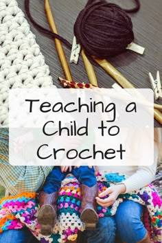 a child sitting on the ground with crochet and knitting needles