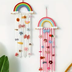 two wall hangings decorated with different types of hair clips and bows, one has a rainbow in the background