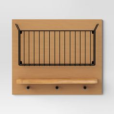 a wooden shelf with black iron bars on it