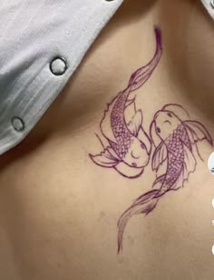 a woman with a tattoo on her stomach has a koi fish in it's belly