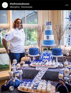 a woman standing in front of a table filled with cakes and cupcakes