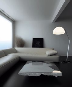 a modern living room with white furniture and large windows