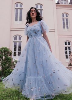 See The Lights, See The Party, The Ball Gowns This beautiful blue gown will make you feel like a true royal. The floral embroidery is a subtle, yet stunning detail, and the full skirt adds a touch of whimsy to the overall look. Perfect for attending a gala or dancing under the stars. Sweetheart neckline 3/4 sheer flutter sleeves Back zipper Ruched bodice Fully lined Consider sizing down Model Details Content + Care 100% Polyester Hand wash only Try On Video Highgrove Dress Try On Video XS & XL Full Sleeve Gown Designs, Simple Gown Designs, Fairytale Clothes, Dresses For Engagement Pictures, Moh Dress, Light Blue Gown, Simple Frock, Outfit Ideas Summer, Dresses Design