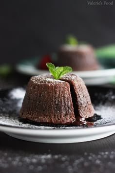 two small cakes sitting on top of a white plate