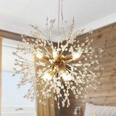 a chandelier hanging from the ceiling in a bedroom