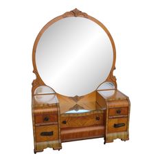 an antique wooden vanity with mirror and drawers