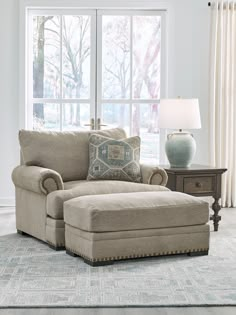 a living room scene with focus on the chair and ottoman