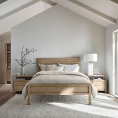 a bedroom with white walls and wooden furniture