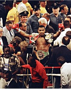 a man with boxing gloves standing in the middle of a crowd