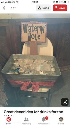 a toilet with a sign that reads waterin'hole on it and an empty tray