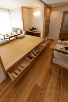 a room with wooden flooring and white walls