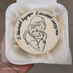 a cake in the shape of a woman holding a baby