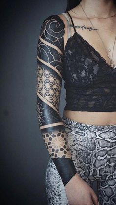 a woman with tattoos on her arm and shoulder