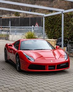 a red sports car parked in front of a building