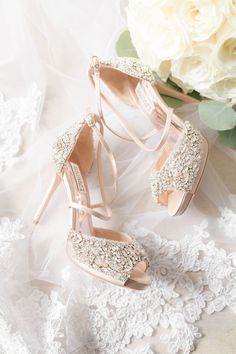 the bride's shoes are adorned with pearls