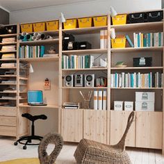 a living room filled with lots of furniture and bookshelves on top of wooden shelves