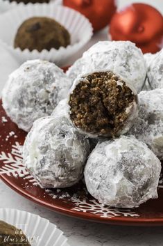 chocolate truffles on a red plate with christmas decorations in the backgroud