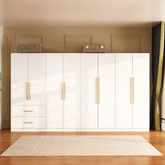 a living room with white furniture and wood floors