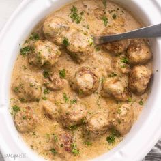 a white bowl filled with meatballs and gravy