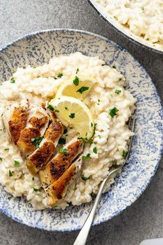 two plates filled with rice and chicken on top of each other next to a fork