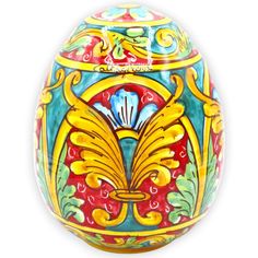 an ornately painted egg is shown on a white background with red, yellow and blue accents