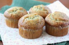 four muffins sitting on top of a napkin