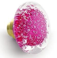 a pink and gold knob with bubbles on it