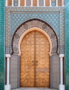 the entrance to an ornate building with wooden doors