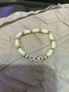 Outer banks bracelet with colors white, pink, orange, and blue. Could  fit adults with the elastic string I use. Casual Multicolor Bracelets With Letter Beads, Casual Multicolor Letter Beads Bracelets, White Letter Beads Stretch Bracelet For Summer, White Stretch Bracelet With Letter Beads For Summer, Casual Orange Stretch Bracelet With Letter Beads, Casual Multicolor Wristband With Letter Beads, White Wristband With Colorful Beads For Friendship, White Colorful Beads Wristband For Beach