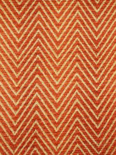 an orange and white zigzag pattern on the surface of a fabric material