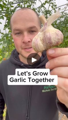 a man holding up a garlic plant with the caption let's grow garlic together