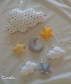 a baby mobile with stars, moon and clouds