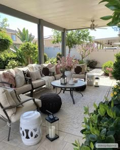 an outdoor living area with couches and tables