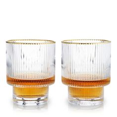 two glasses sitting next to each other on a white surface